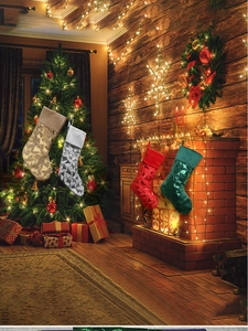 Macro view of metallic Christmas stocking ornaments hanging on a decorated tree