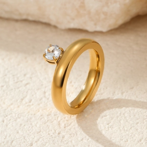 Detailed shot of a 18k gold-plated stainless steel ring with a round four-prong solitaire