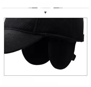 Detail of black wool baseball cap with ear flaps and metallic BEST 1988 decoration