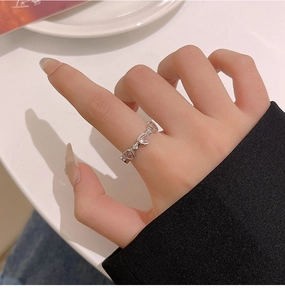 Close-up of elegant pink heart zircon ring on finger with refined french style