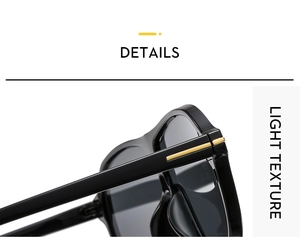 Detail of metal T decoration on hinge of black oversized sports sunglasses