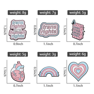 Detail view of colorful enamel pin set with rainbow hearts and creative cartoon slogans