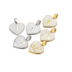 Golden and silver heart pendants with shell inlay and various alphabet letters