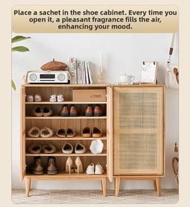Macro view of white camellia plaster diffuser in a wooden shoe cabinet for home fragrance