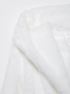 Detail of the white faux fur coat collar and shoulder with a smooth silk lining