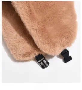 Close-up of brown faux fur winter hat texture with black plastic release buckle