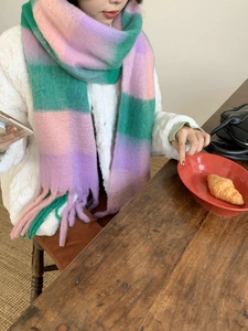 Detailed close-up of rainbow plaid tassel scarf with soft thick cashmere-like texture