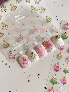 Close-up of gold Christmas tree nail art stickers with snowflake designs and 3D textures