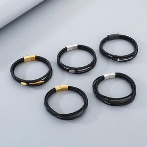 Detail of multi-layer braided leather bracelets with metallic magnetic clasps for men