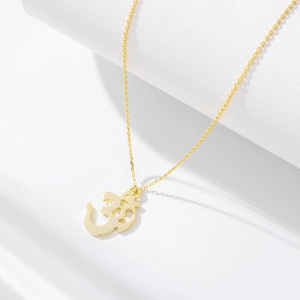 Detailed macro shot of the golden S925 sterling silver Om symbol pendant necklace