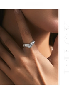 Macro shot of V-shaped s925 silver ring featuring baguette-cut and pave diamonds
