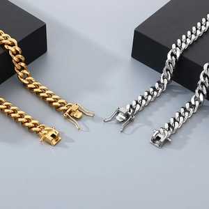 Close-up of gold and silver stainless steel Cuban link chains with secure box clasps