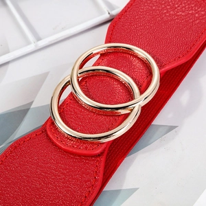 Red elastic waist belt with textured faux leather and gold double O-ring buckle