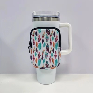 Close-up of neoprene 40oz tumbler pouch with colorful feather pattern on a white mug
