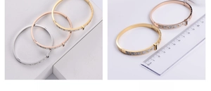 Detail of geometric titanium bangle with crystals and 6cm diameter size measurement