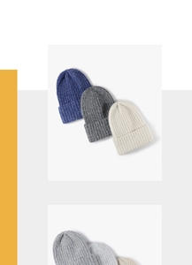 Detail of ribbed knit beanies in blue, grey and beige with thick cuffed edges