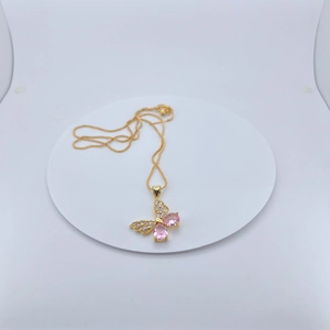 Gold plated butterfly necklace featuring pink teardrop gemstones on white display stand