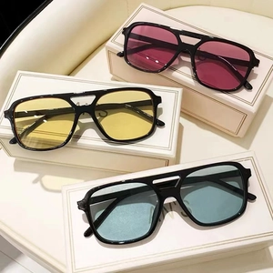 Close-up of three aviator sunglasses with colorful lenses and double bridge design