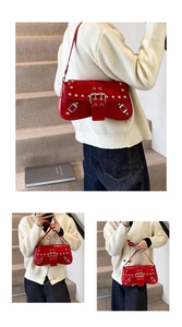 Detail of red faux leather shoulder bag with silver metallic studs and moto style buckles