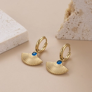 Gold fan-shaped titanium earrings with blue zircon inlays and radiating relief textures