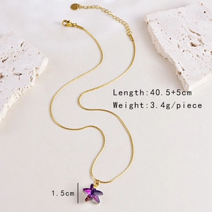 Detail shot of a purple gradient star pendant with golden chain and size measurements