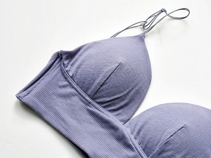 Detail of purple ribbed cotton bra featuring thin straps and fine knitted texture
