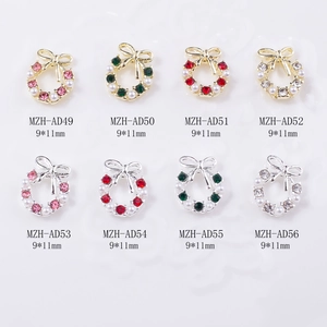 Macro view of Christmas wreath nail charms with colorful rhinestones and bow accents
