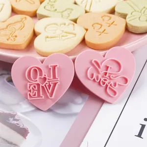 Pink heart cookie molds with LOVE and I love you engraving for Valentine baking