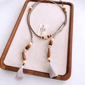 Ethnic wood bead tassel belt with minimalist beaded design and brown woven rope detail