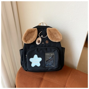 Detail of cute puppy backpack featuring plush brown ears and star design for kids