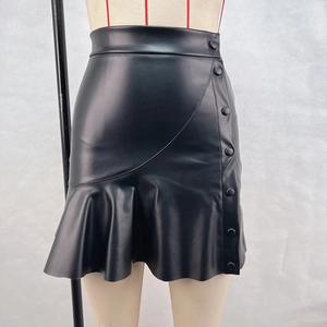 Detail view of black PU leather mini skirt featuring decorative side buttons and ruffle hem