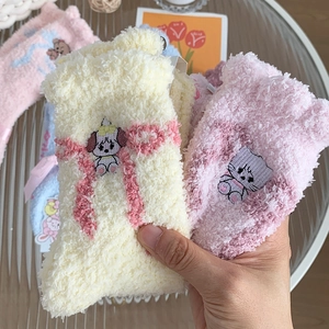 Cute coral fleece winter socks with animal embroidery displayed in hand for home wear