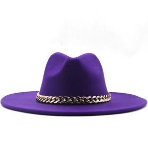 Close-up of deep purple wool jazz fedora hat with a thick gold chain decoration