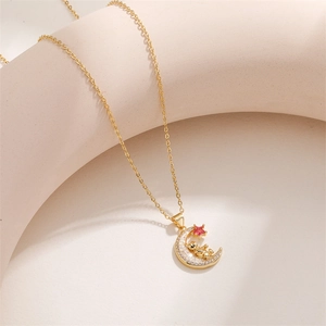 Detail of gold-plated moon and bear pendant with sparkling zircon and pink star