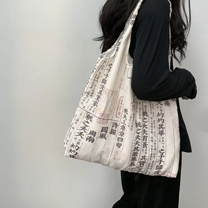 Close-up of vintage canvas bag with classical Chinese calligraphy print and durable texture