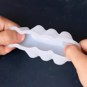 Close-up showing the flexibility and elastic texture of the silicone wavy candle mold