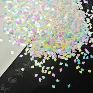 Close-up of pastel cloud shaped glitter sequins with iridescent finish for DIY crafts