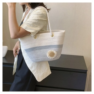 Fashionable floral woven tote bag with daisy detail shown on shoulder for daily use