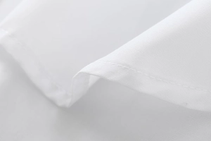 Macro shot of precise stitching and fine texture on white cotton shirt fabric