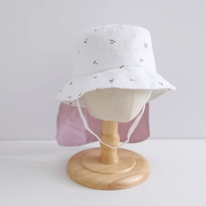 Detail of floral embroidery and pink plaid neck flap on children's sun hat