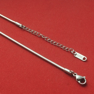 Macro shot of silver stainless steel snake chain with lobster clasp and extension link