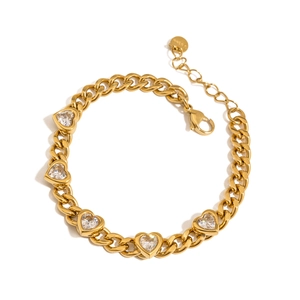 Macro detail of gold chunky curb chain bracelet featuring five heart-shaped cubic zirconia