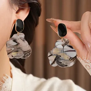 Artistic resin flower drop earrings with black oval tops and ink-wash petal pendants