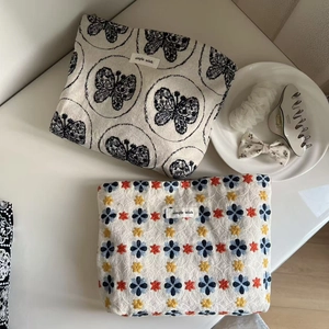 Artistic canvas cosmetic bags with butterfly embroidery and elegant minimalist textures