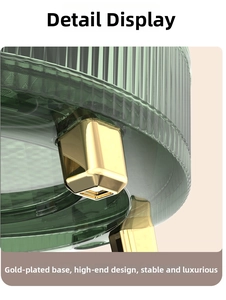 Detail of green striped transparent storage box with decorative gold plated feet base