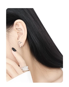 Close-up of minimalist S925 sterling silver pearl stud earring on model's ear