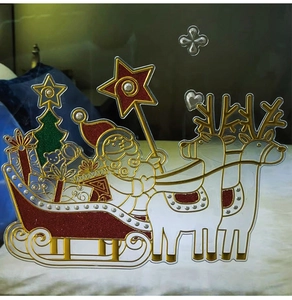 Detail of Christmas window stickers featuring Santa, reindeer and golden glitter accents
