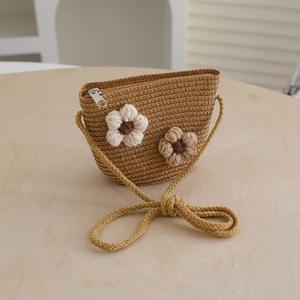 Handcrafted straw crossbody bag featuring crochet 3D flower accents and zipper closure