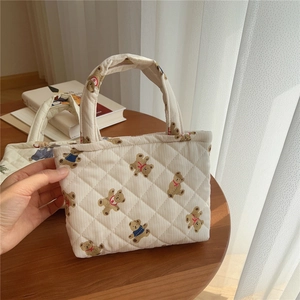 Detailed view of quilted cotton mini tote with zipper and cute cartoon bear print