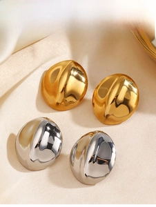 Detailed close-up of polished oval geometric earrings in gold and silver finishes